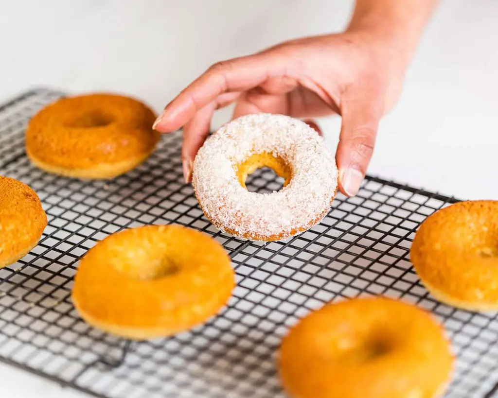 Baked doughnuts brushed with butter and doused generously with sugar