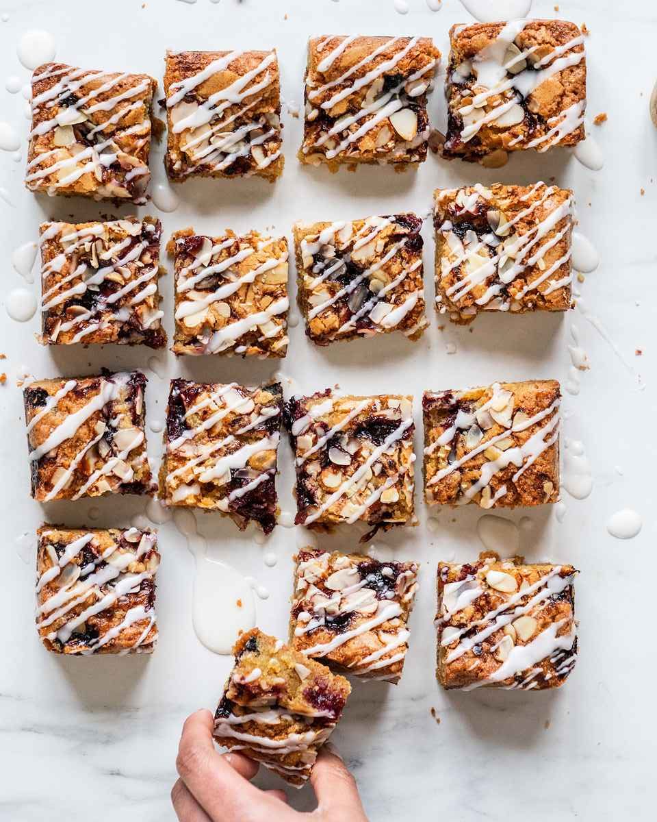 Cherry bakewell blondie squares drizzles with a yummy icing glaze