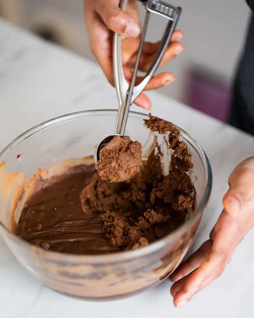 Scooping the chilled dough for brownie cookies