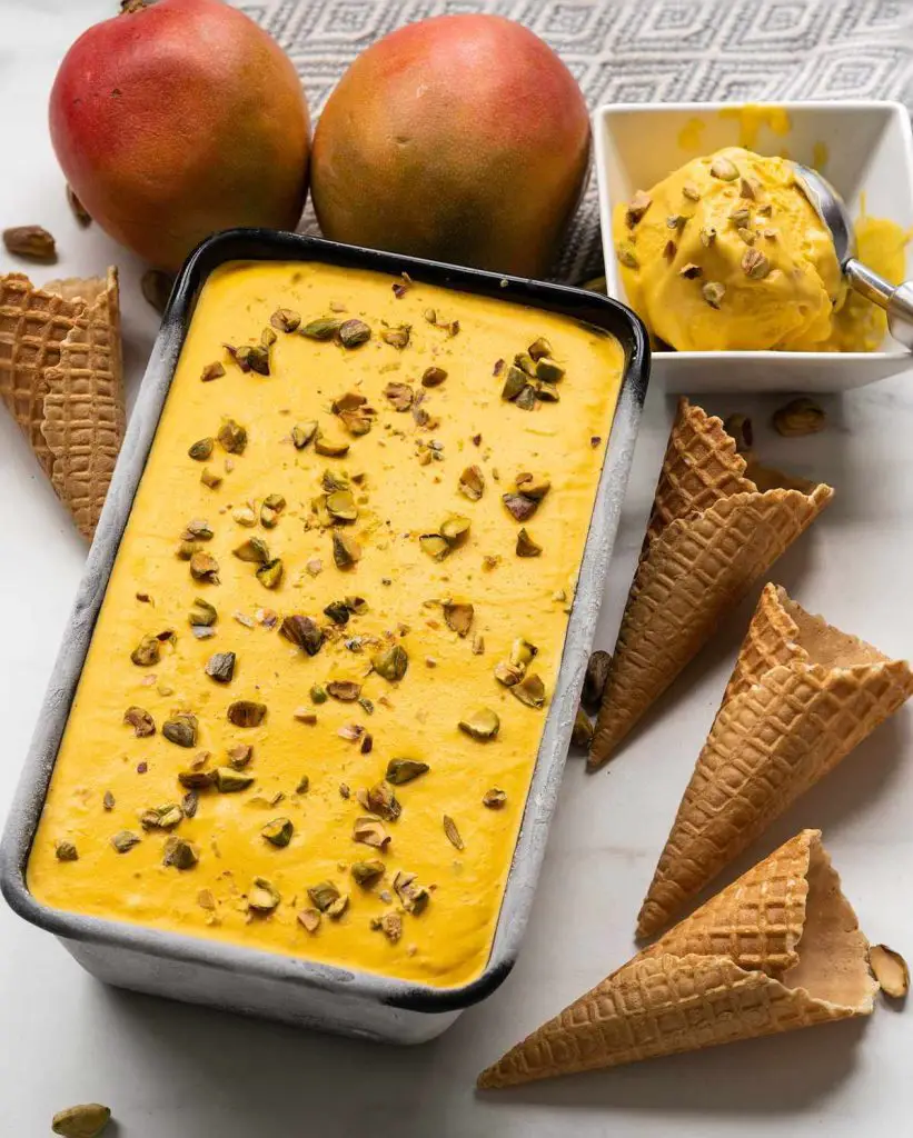 Mango kulfi. Creamy no churn mango ice cream with pistachio and cardamom makes the most heavenly summertime treat! Recipe by movers and bakers