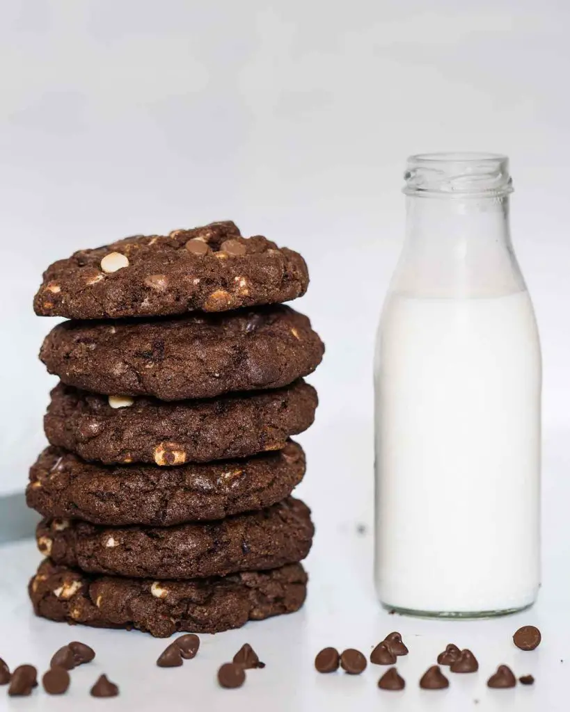 A stack of triple chocolate NYC cookies and a drink of cold milk. Perfect! Recipe by movers and bakers
