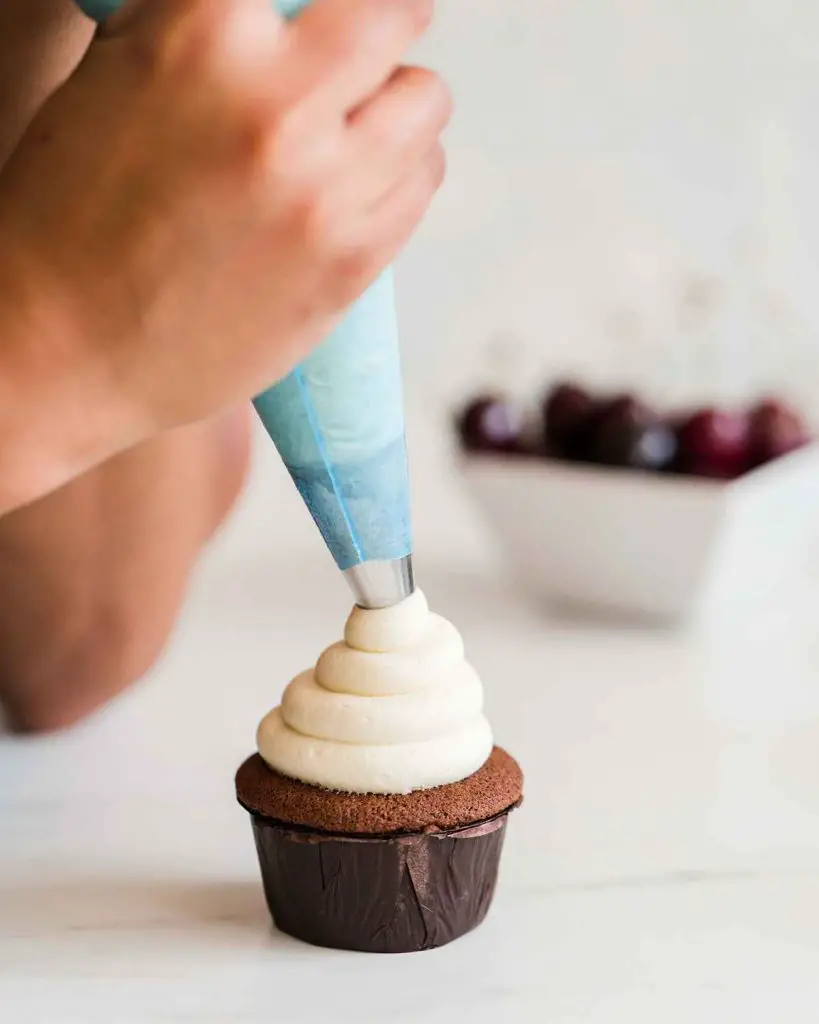 Buttercream swirl on the Black Forest cupcake. Recipe by movers and bakers.