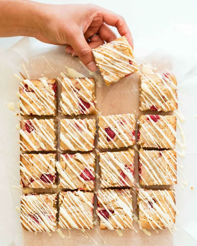 Sneaking a piece of raspberry white chocolate blondies from the batch! Recipe by movers and bakers