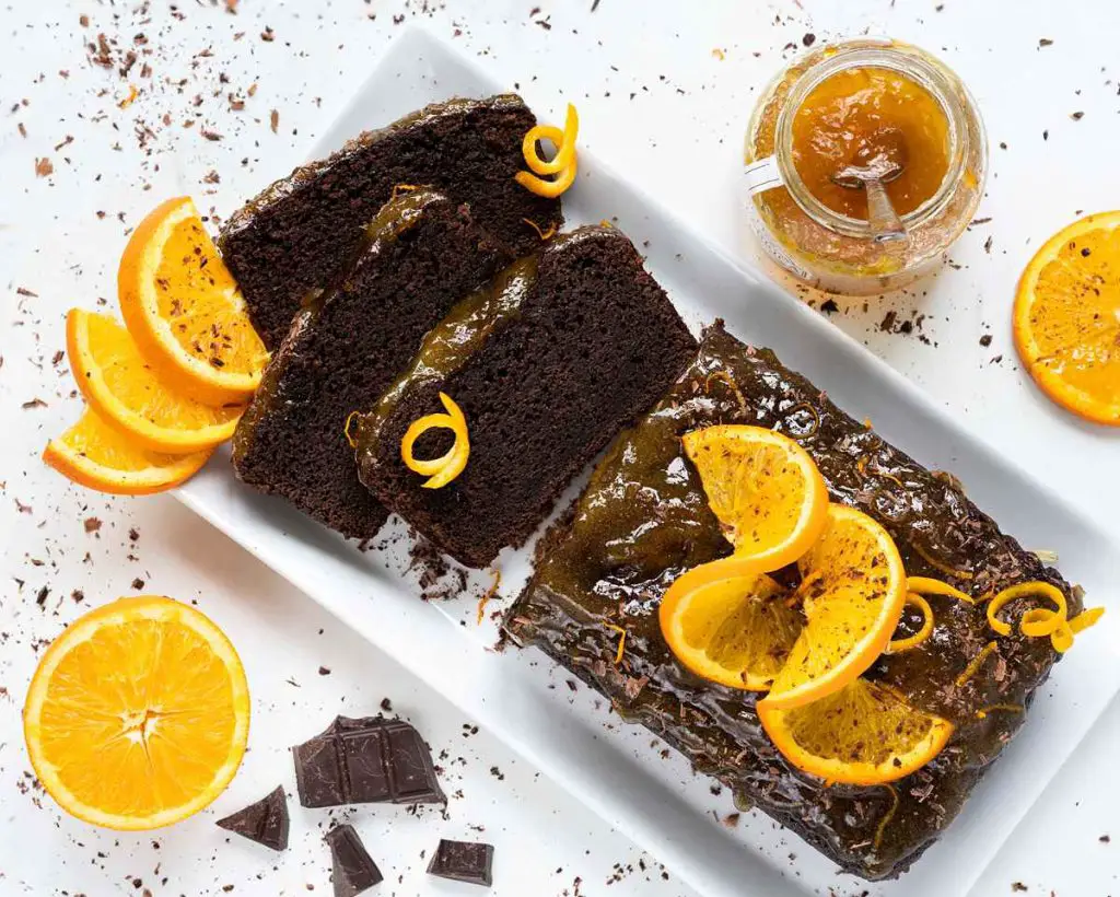 A rich, deep chocolate loaf packed with beautiful flavours and smothered with a beautiful marmalade glaze. Recipe by movers & bakers