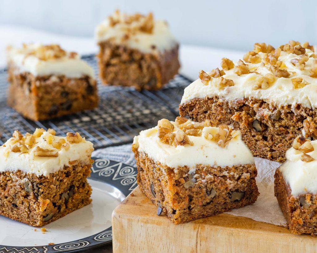 carrot cake tray bake with walnuts and lashings of cream cheese icing. Recipe by movers and bakers