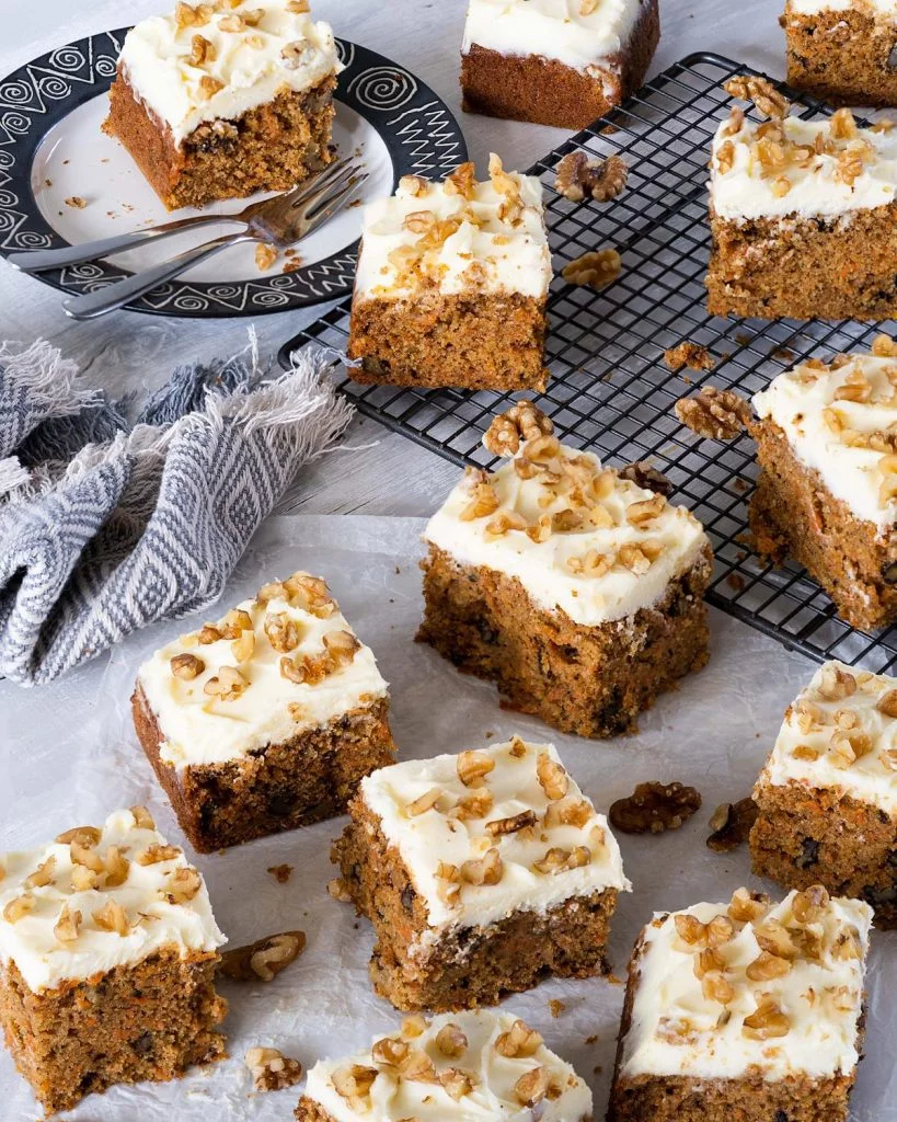 carrot cake tray bake with walnuts and lashings of cream cheese icing. Recipe by movers and bakers