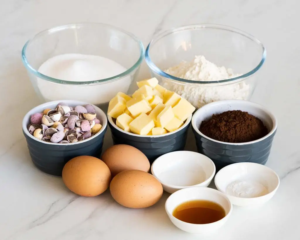 ingredients needed for this bake: unsalted butter, cocoa powder, caster sugar, eggs, vanilla, plain (all purpose) flour, baking powder, salt and mini eggs. Recipe by movers and bakers