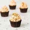 Banoffee cupcakes. Beautiful banoffee cupcakes with a biscuit base, hidden caramel centre, caramel buttercream and chocolate shavings. Perfect for all banana and caramel lovers! Recipe by movers and bakers