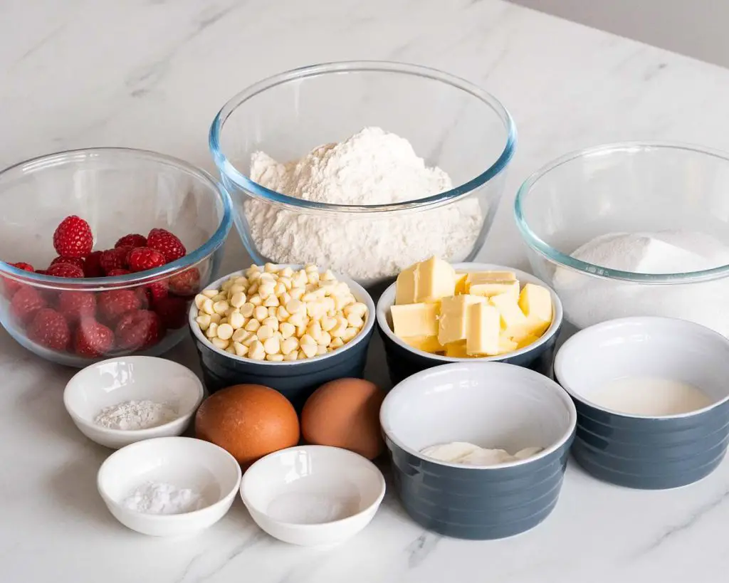 Ingredients needed for the cake: butter, caster sugar, plain (all purpose) flour, baking powder, bicarbonate of soda (baking soda), salt, yogurt, milk, eggs, white chocolate chops and fresh raspberries. Recipe by movers and bakers.