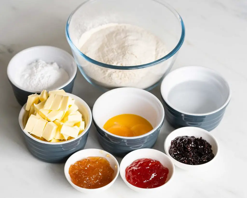 Ingredients needed for this bake: plain (all purpose) flour, icing (powdered) sugar, unsalted butter, egg yolks, ice cold water and jam. Recipe by movers and bakers