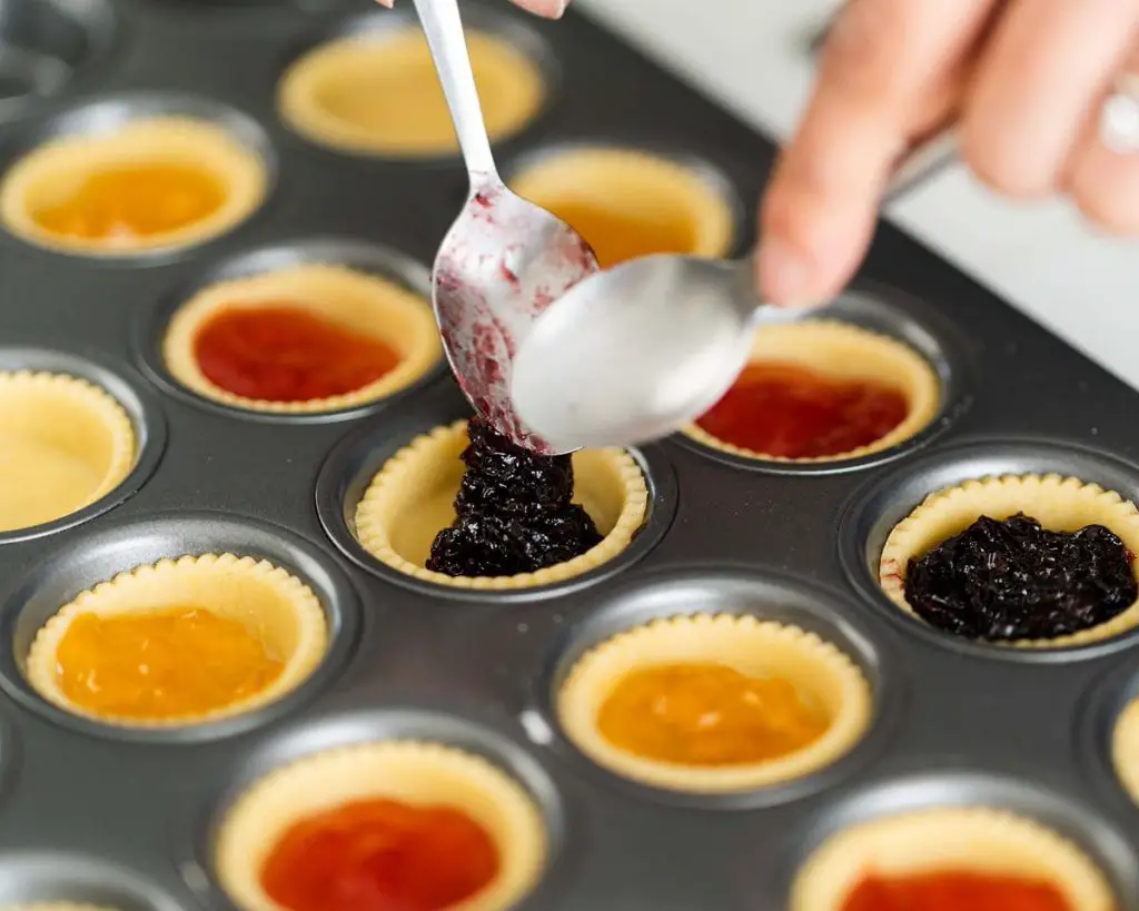 Carefully fill your pastry shells with jam before baking. Recipe by movers and bakers