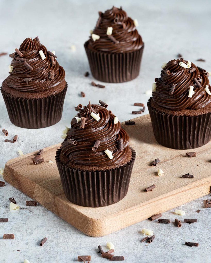 Chocolate fudge cupcakes. Light chocolate cupcakes topped with an INCREDIBLE chocolate fudge icing and chocolate curls, these are a chocolate lover's dream come true! Recipe by movers and bakers