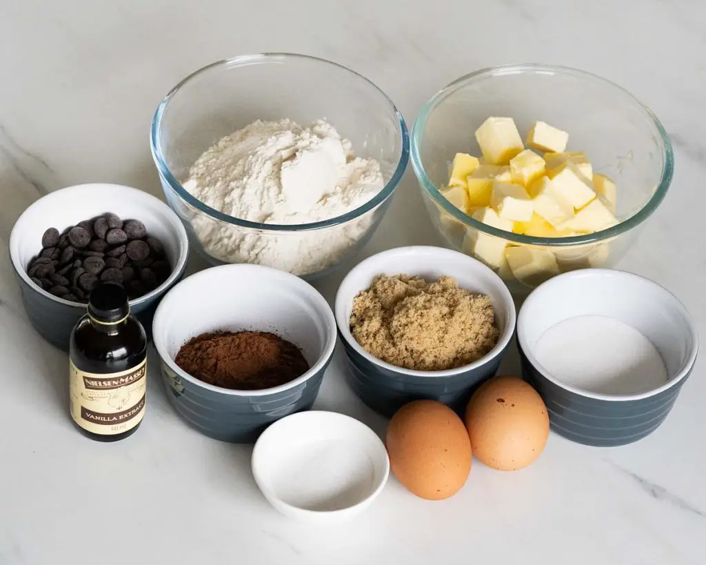 Ingredients needed for this bake: unsalted butter, brown sugar, caster sugar, dark chocolate, eggs, vanilla, plain (all purpose) flour, cocoa powder, salt, milk and sprinkles. Recipe by movers and bakers