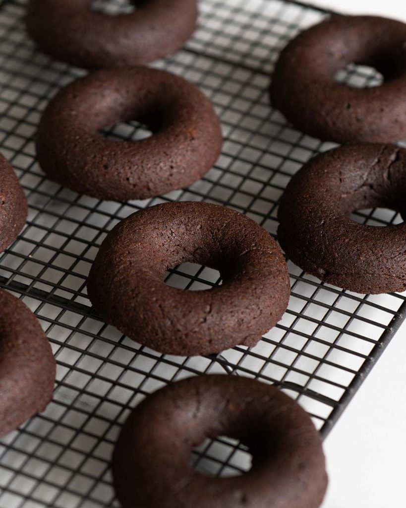 Baked and cooled, these brownie donuts are ready to be decorated! Recipe by movers and bakers