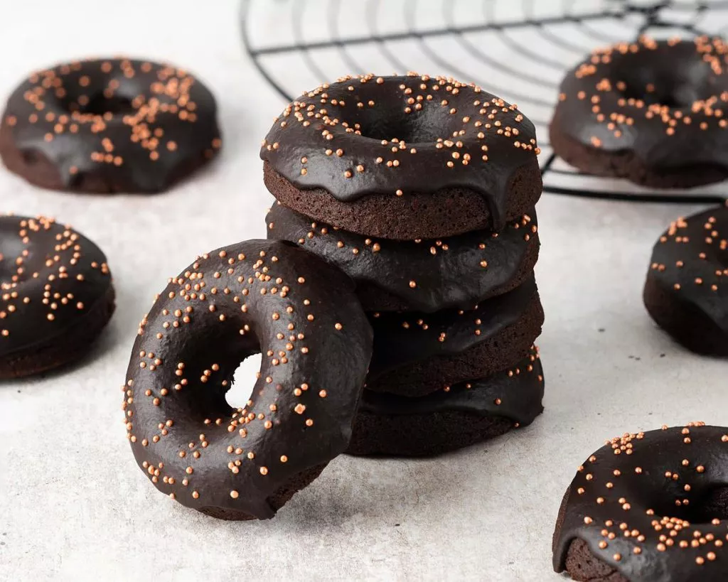 Bronuts aka brownie donuts are delicious fudgy chocolate brownies in a donut form! Smothered in a rich chocolate glaze and lots of sprinkles, these deep rich donuts are sure to be a crowd pleaser! Recipe by movers and bakers