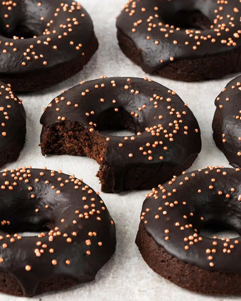Bronuts aka brownie donuts are delicious fudgy chocolate brownies in a donut form! Smothered in a rich chocolate glaze and lots of sprinkles, these deep rich donuts are sure to be a crowd pleaser! Recipe by movers and bakers