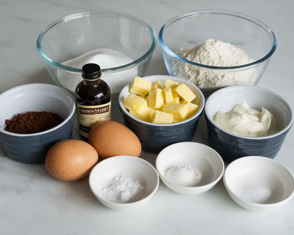 Ingredients for the cupcakes: plain (all purpose) flour, cocoa powder, baking powder, baking soda, salt, unsalted butter, caster sugar, eggs, vanilla and yogurt. Recipe by movers and bakers