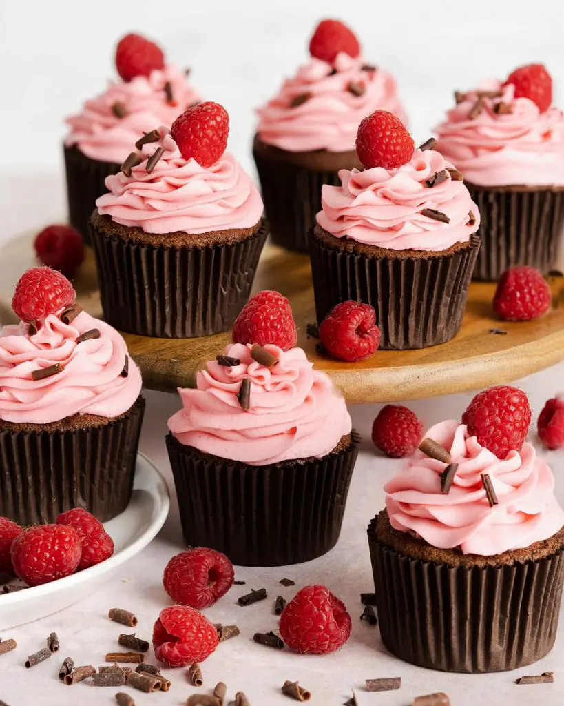 My chocolate raspberry cupcakes are delicious light and fluffy chocolate cupcakes topped with a tangy and sweet fresh raspberry buttercream. It is crowned with chocolate curls and a single raspberry to finish. Recipe by movers and bakers