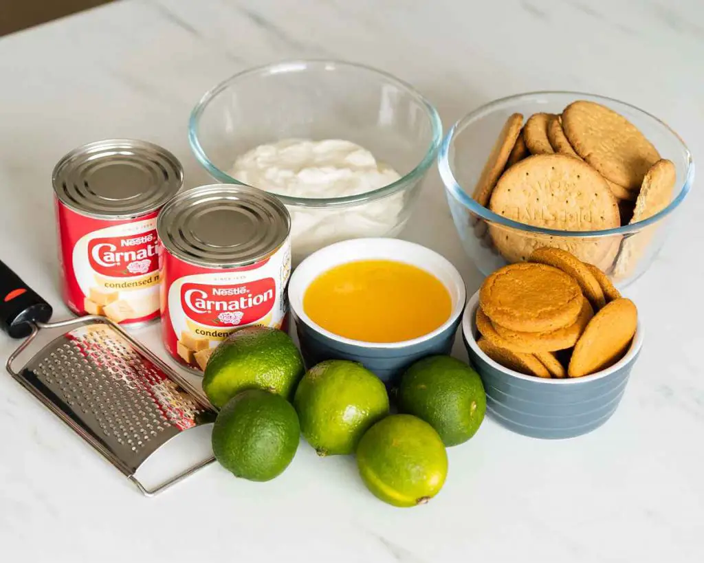 Ingredients needed for this bake: digestive biscuits, ginger biscuits, melted unsalted butter, sweetened condensed milk, yogurt (I use Greek yogurt), zest and juice of limes, double cream and icing sugar. Recipe by movers and bakers