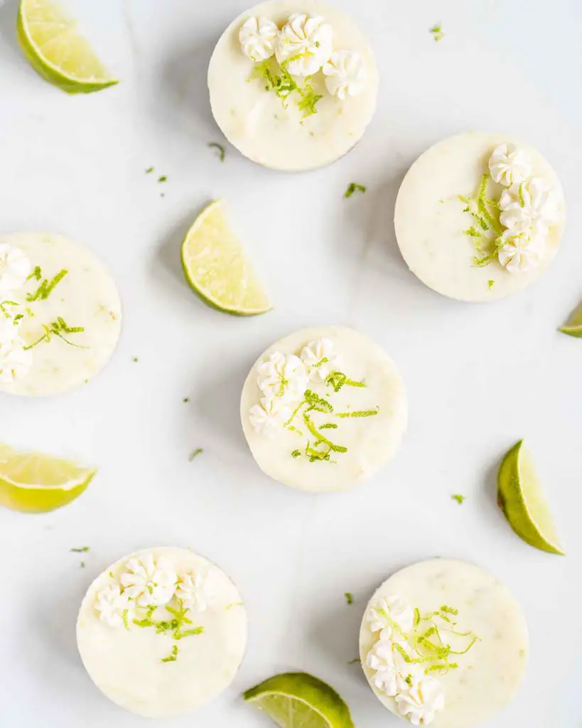 Mini key lime pies. Beautiful buttery biscuit bases, topped with a creamy and dreamy sweet and tangy lime filling, decorated with some softly whipped cream and strands of lime zest. Insanely delicious! Recipe by movers and bakers
