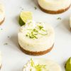 Mini key lime pies. Beautiful buttery biscuit bases, topped with a creamy and dreamy sweet and tangy lime filling, decorated with some softly whipped cream and strands of lime zest. Insanely delicious! Recipe by movers and bakers