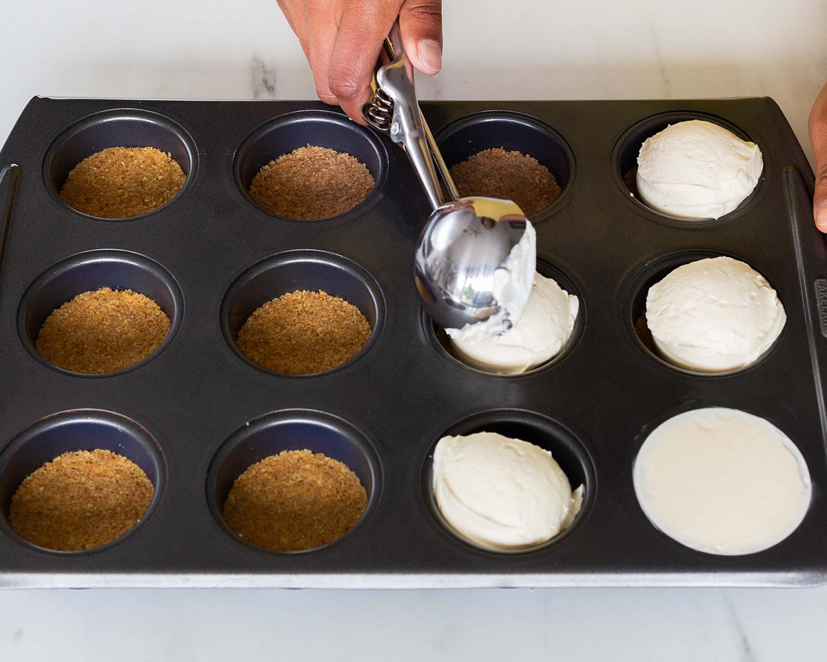 Scooping the filling evenly over the biscuit bases. Recipe by movers and bakers