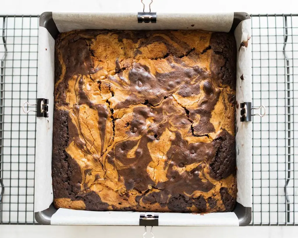 Baked deliciousness fresh from the oven! Wait until cool before cutting the brownie blondies into squares and enjoying. Recipe by movers and bakers