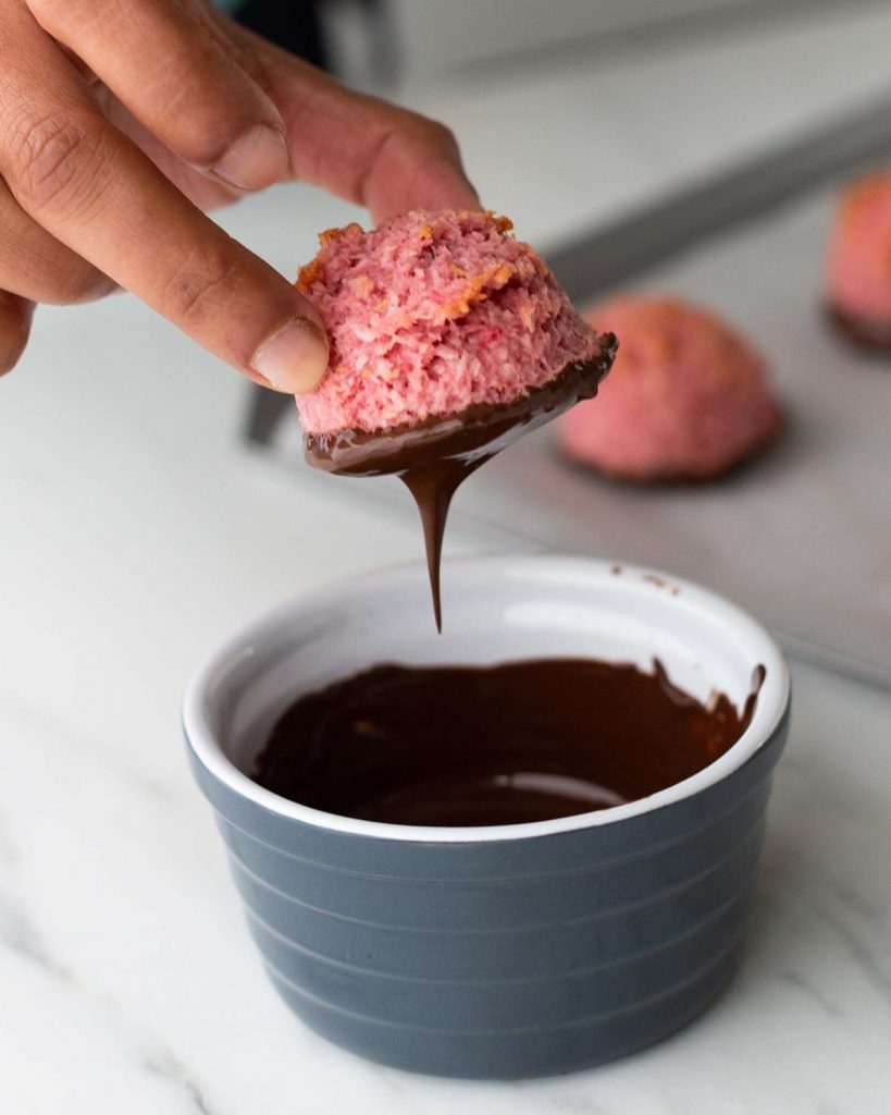 Once the macaroons are cool, the bases are dipped in melted chocolate and they are then drizzled with extra chocolate. Recipe by movers and bakers