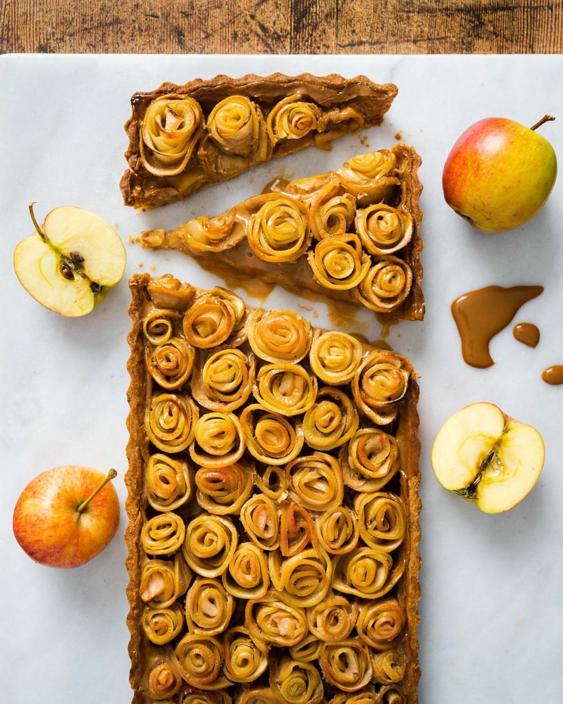 Caramel apple tart. A buttery shortbread pastry base, filled with rich caramel and topped with beautiful apple roses. Recipe by movers and bakers