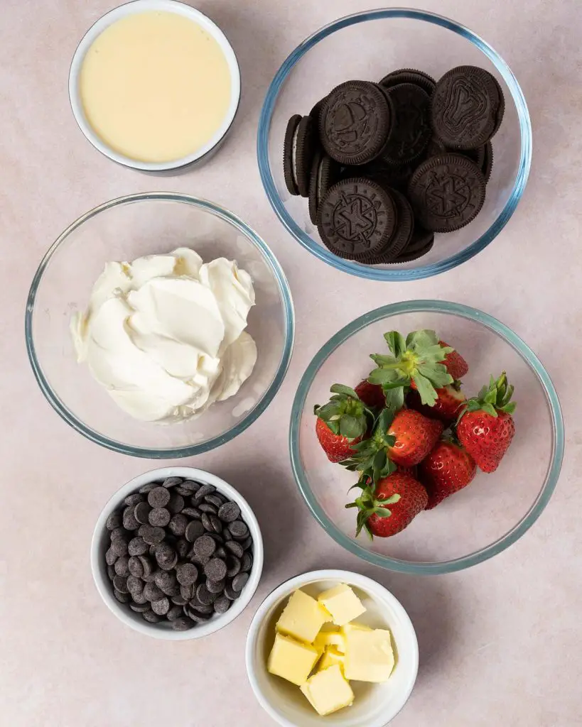 Ingredients needed: cookies and cream (oreo) biscuits, unsalted butter, cream cheese, condensed milk, dark chocolate and strawberries. Recipe by movers and bakers