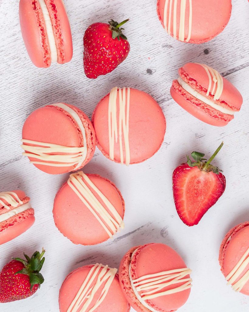 Strawberry macarons. Crisp, chewy, sweet, soft and nutty. And totally irresistible, filled with sweet vanilla buttercream and delicious strawberry jam. Recipe by movers and bakers