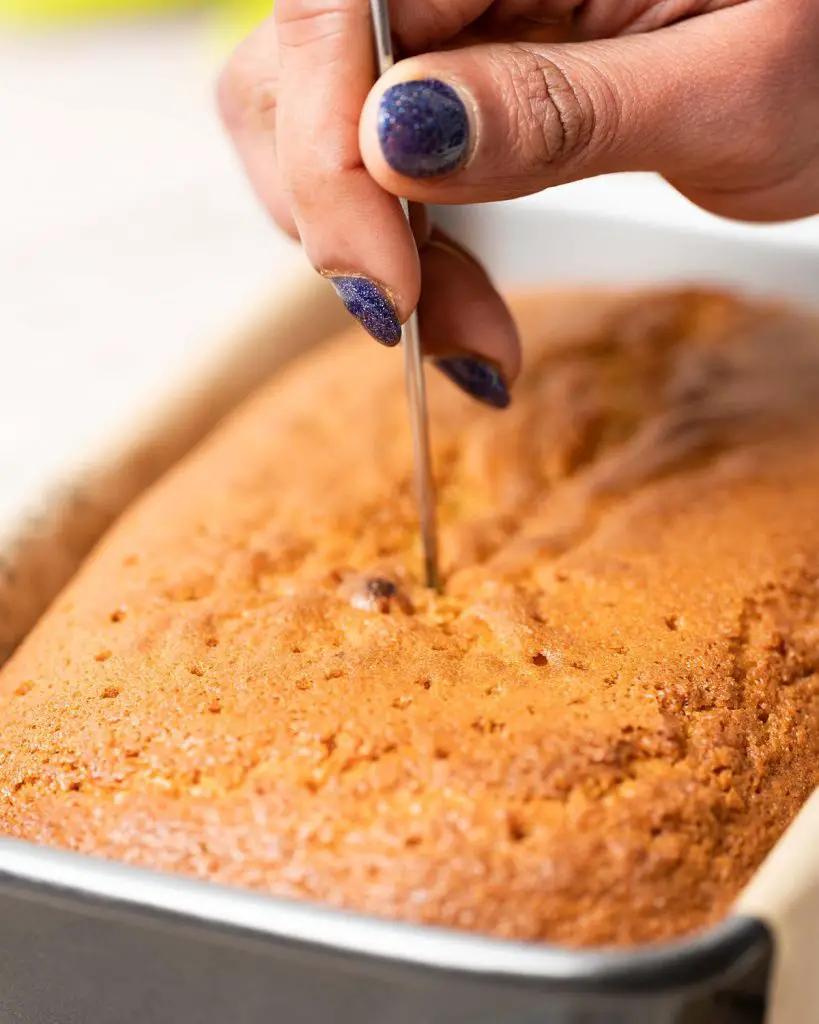 Once out of the oven, poke the cake all over with a skewer...