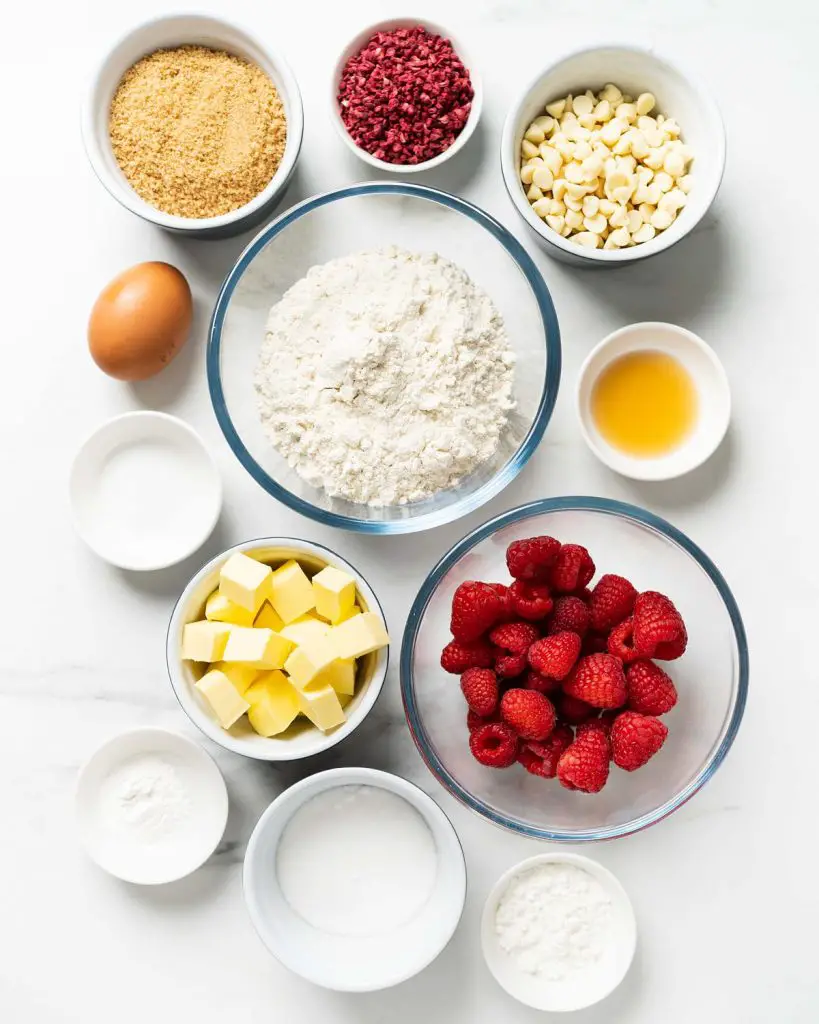 Ingredients required: unsalted butter, brown sugar, caster sugar, vanilla, plain (all purpose) flour, cornflour (cornstarch), baking powder, salt, egg, white chocolate chips, freeze dried raspberries and fresh raspberries. Recipe by movers and bakers